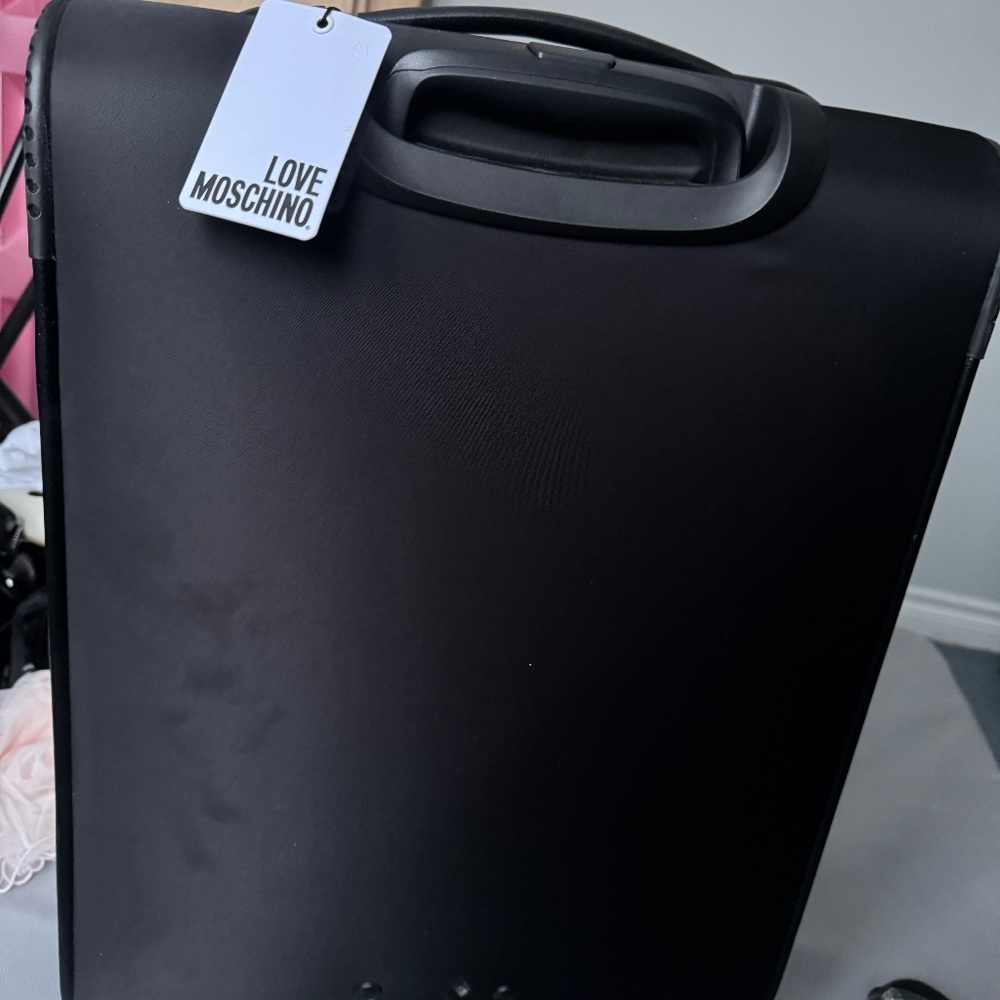 Brand new carry on luggage Love Moschino